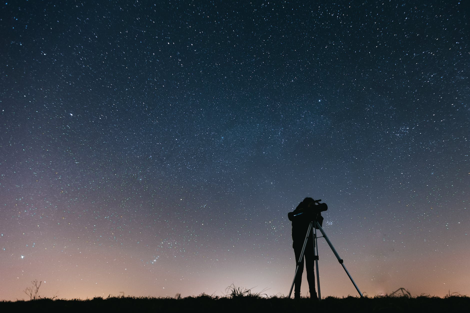 silhouette of person under starry sky